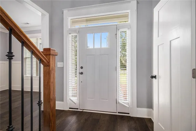 a view of an entryway with wooden floor