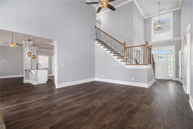 a view of an empty room with wooden floor and a cabinet