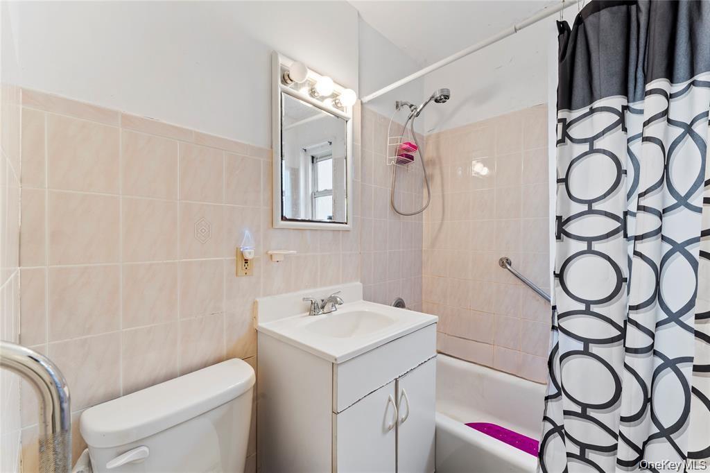 251-29 61st Avenue, Unit 2719 Queens, NY 11362 - Photo 15 of 19 a bathroom with a sink toilet and shower