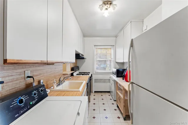 a room with furniture a flat screen tv and a sink