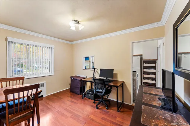 a view of a workspace with furniture and a window