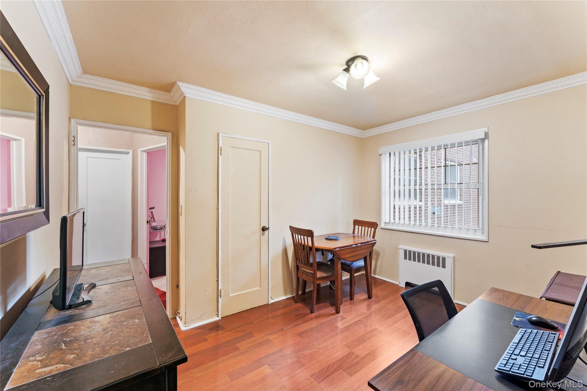 251-29 61st Avenue, Unit 2719 Queens, NY 11362 - Photo 9 of 19 a living room with furniture and a window