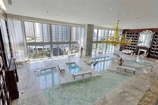 a living room with furniture and a floor to ceiling window