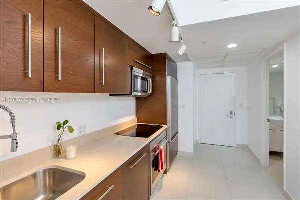 a kitchen with a sink and a refrigerator