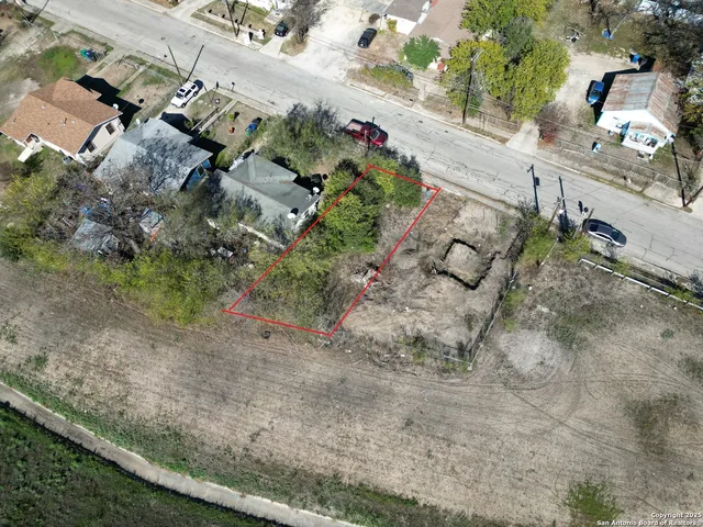 an aerial view of a house with a yard