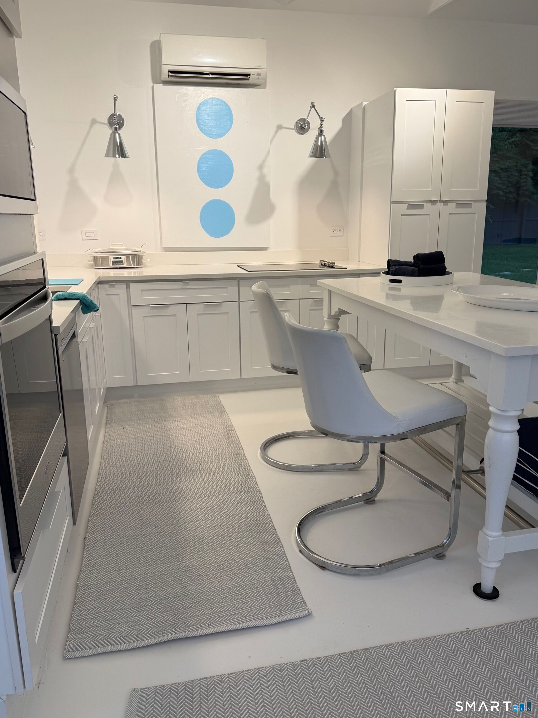 4 A Stoneboat Road Westport, CT 06880 - Photo 11 of 24 a kitchen with a table chairs sink and cabinets