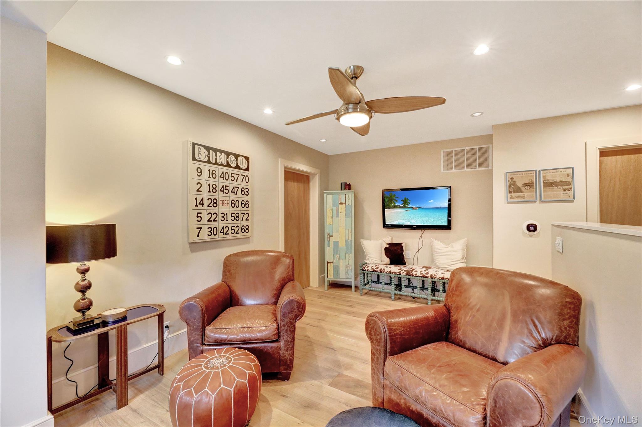 198 South Country Road Remsenburg, NY 11960 - Photo 43 of 49 a living room with furniture and a flat screen tv