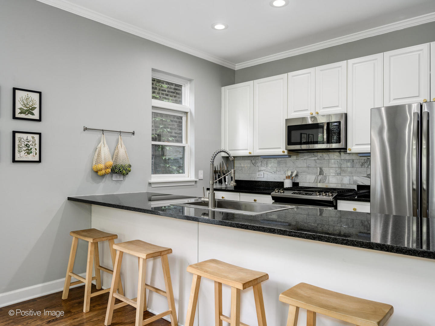 4315 North Kenmore Avenue, Unit 1N Chicago, IL 60613 - Photo 10 of 27 a kitchen with stainless steel appliances a stove a sink a microwave a refrigerator and cabinets