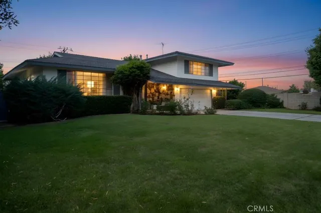 a front view of a house with a garden