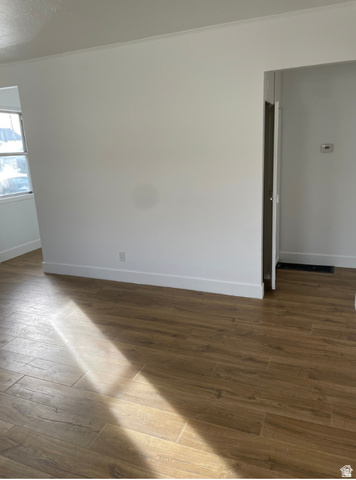 230 North 2nd Street Tooele, UT 84074 - Photo 10 of 18 Wood-finish flooring throughout, complemented by white baseboards and crown molding