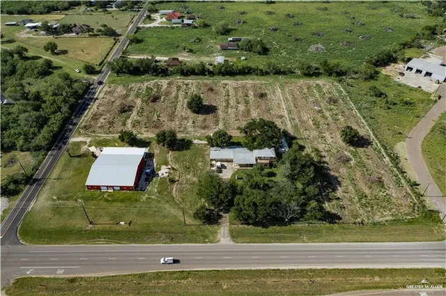 an aerial view of a residential houses with outdoor space