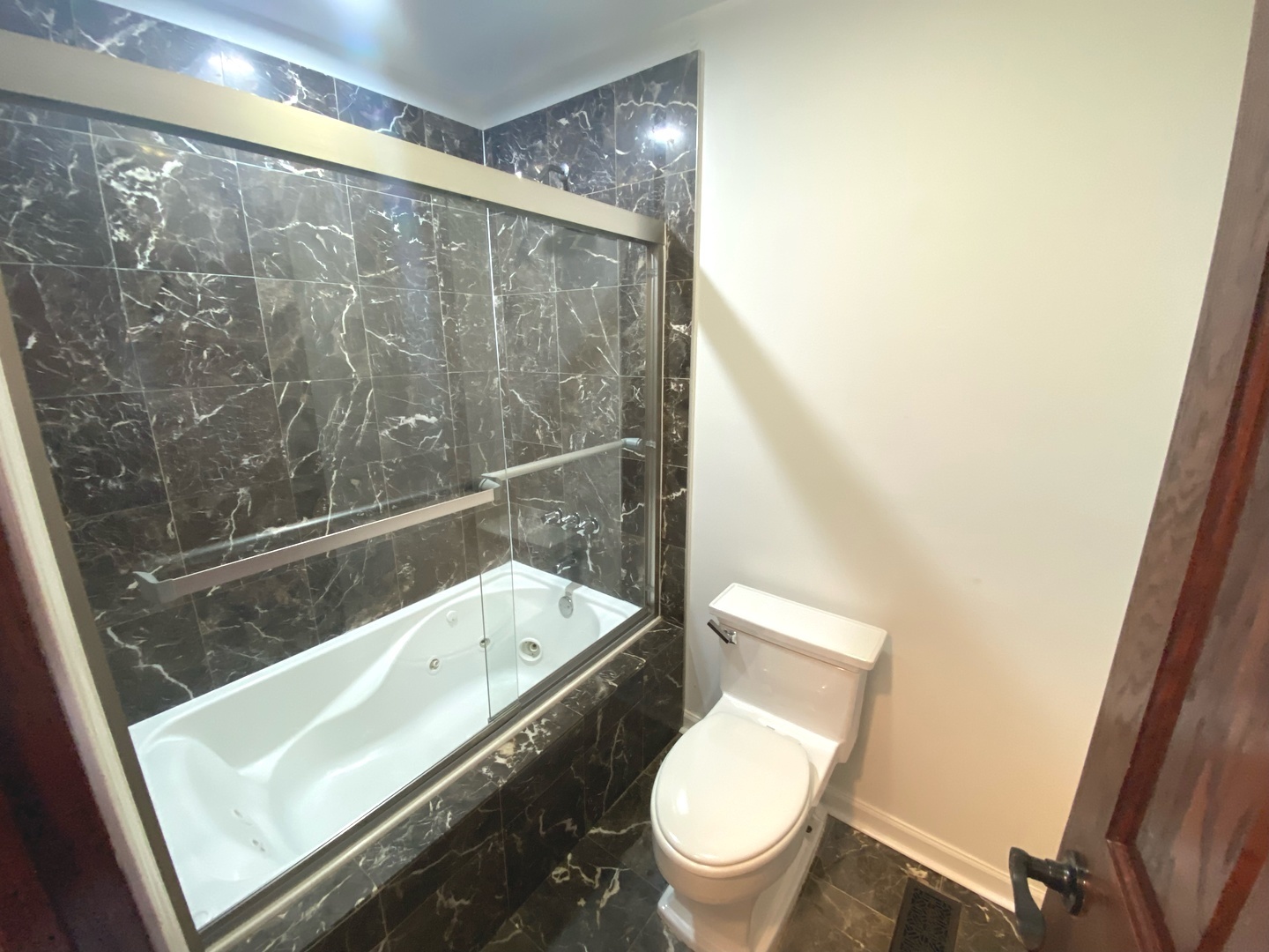 282 Seabury Road Bolingbrook, IL 60440 - Photo 26 of 41 a bathroom with a granite countertop toilet and a shower