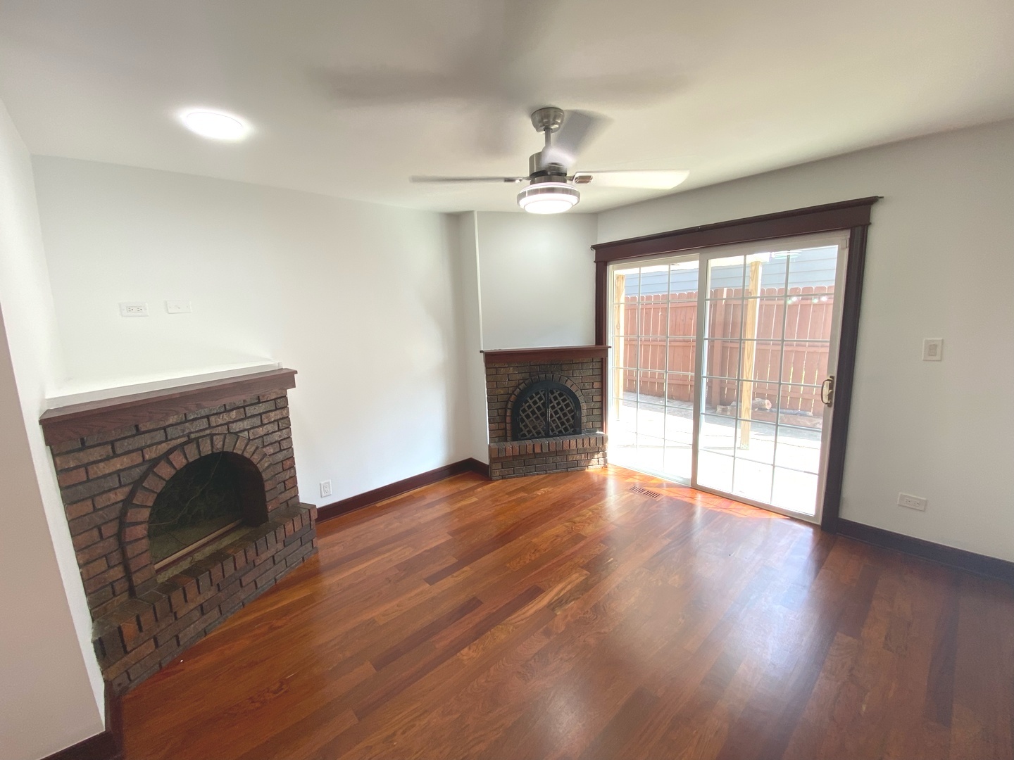 282 Seabury Road Bolingbrook, IL 60440 - Photo 6 of 41 an empty room with wooden floor fireplace and windows
