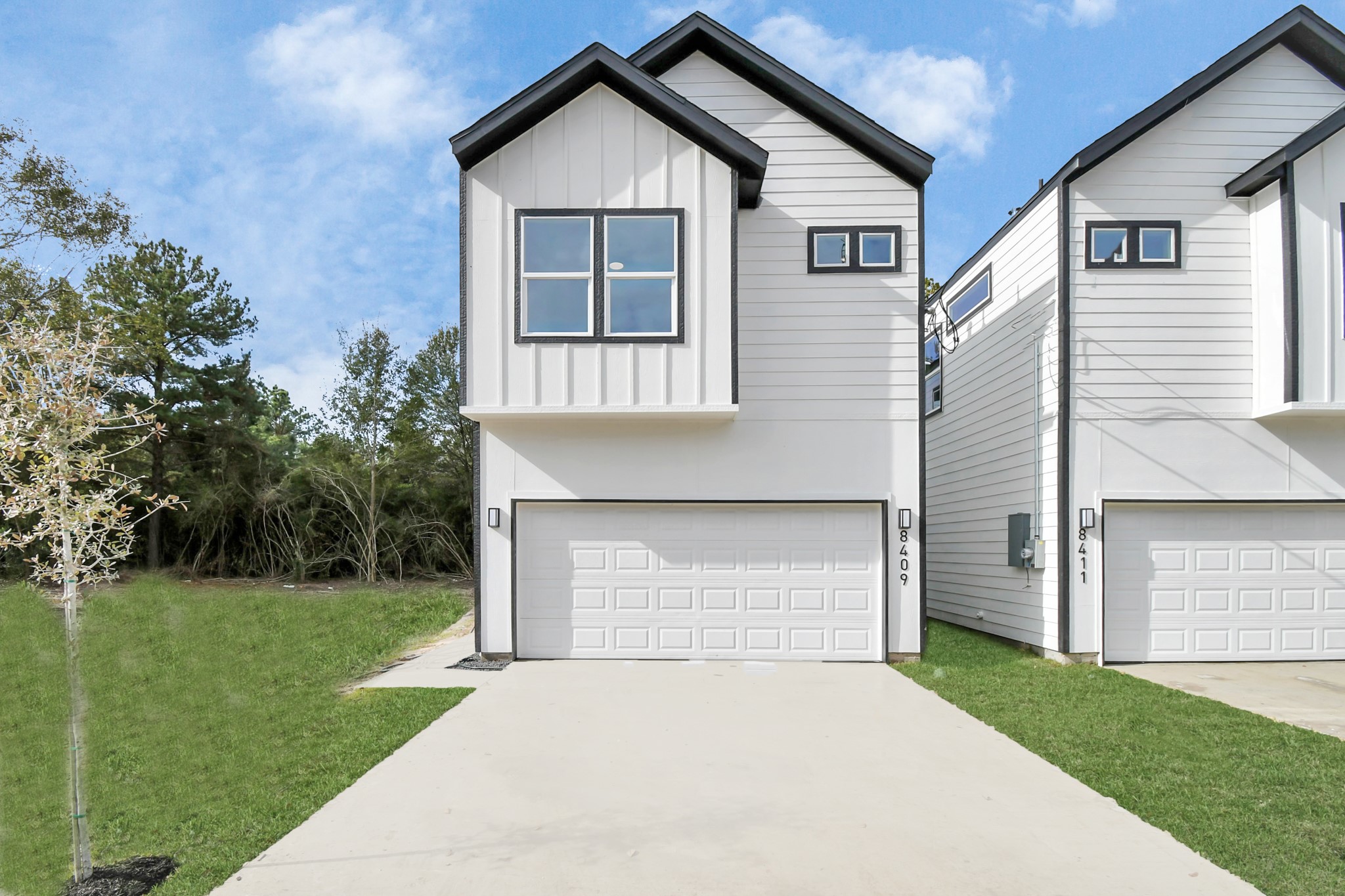 8409 Sunnyhill Street Houston, TX 77088 - Photo 5 of 13 a front view of a house with a yard and garage