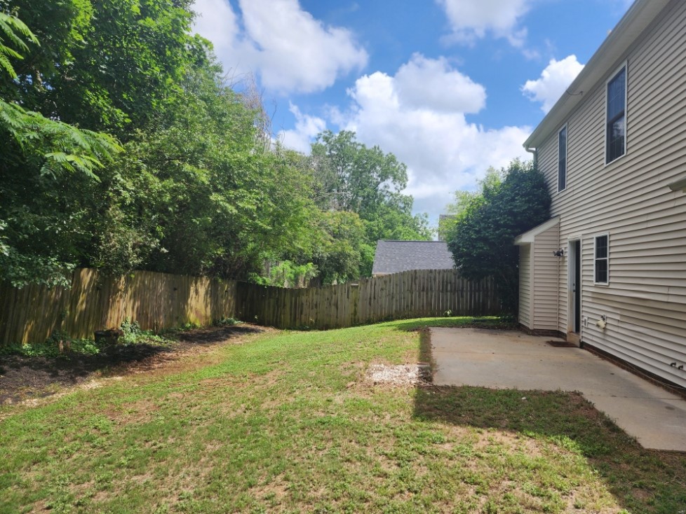 328 Springfield Circle Easley, SC 29642 - Photo 29 of 29 A fully fenced backyard with ample green space and a patio, perfect for outdoor enjoyment.