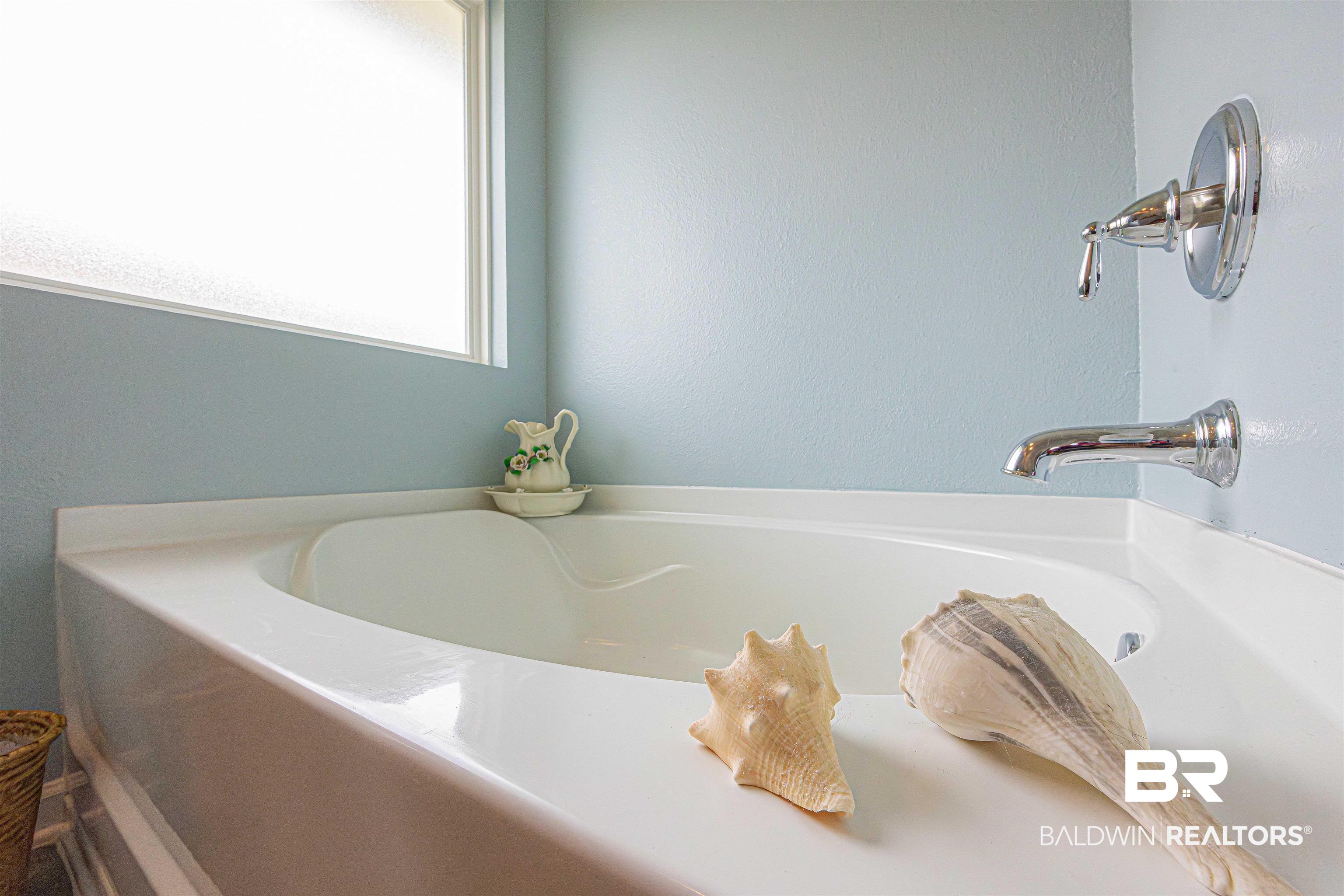 14843 Forsythia Loop Silverhill, AL 36576 - Photo 28 of 51 Bathroom with a garden tub and a textured wall