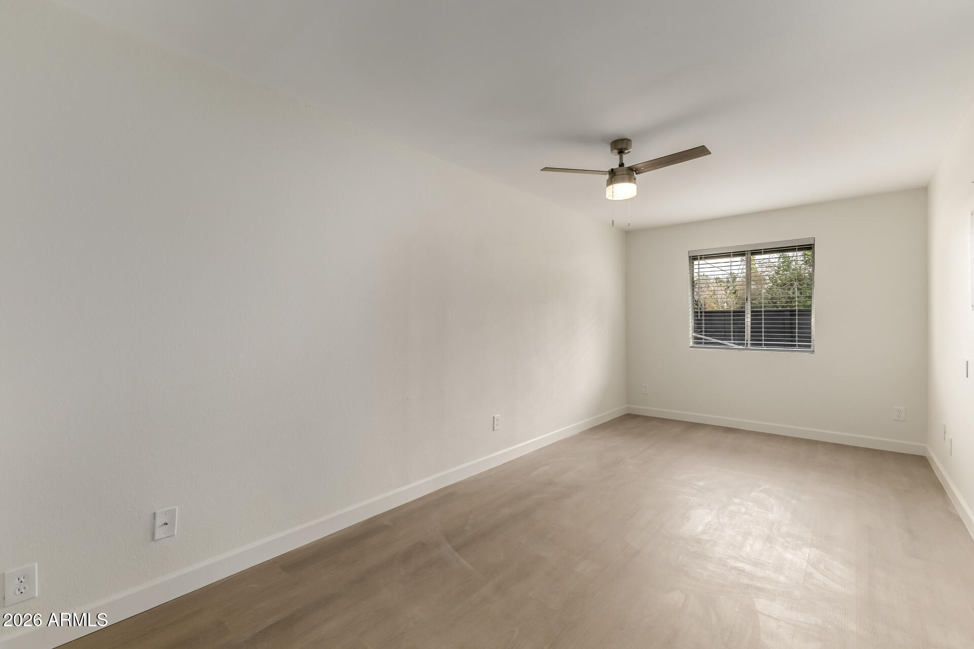 936 West Rio Salado Parkway, Unit 4 Mesa, AZ 85201 - Photo 11 of 20 an empty room with a window and a ceiling fan
