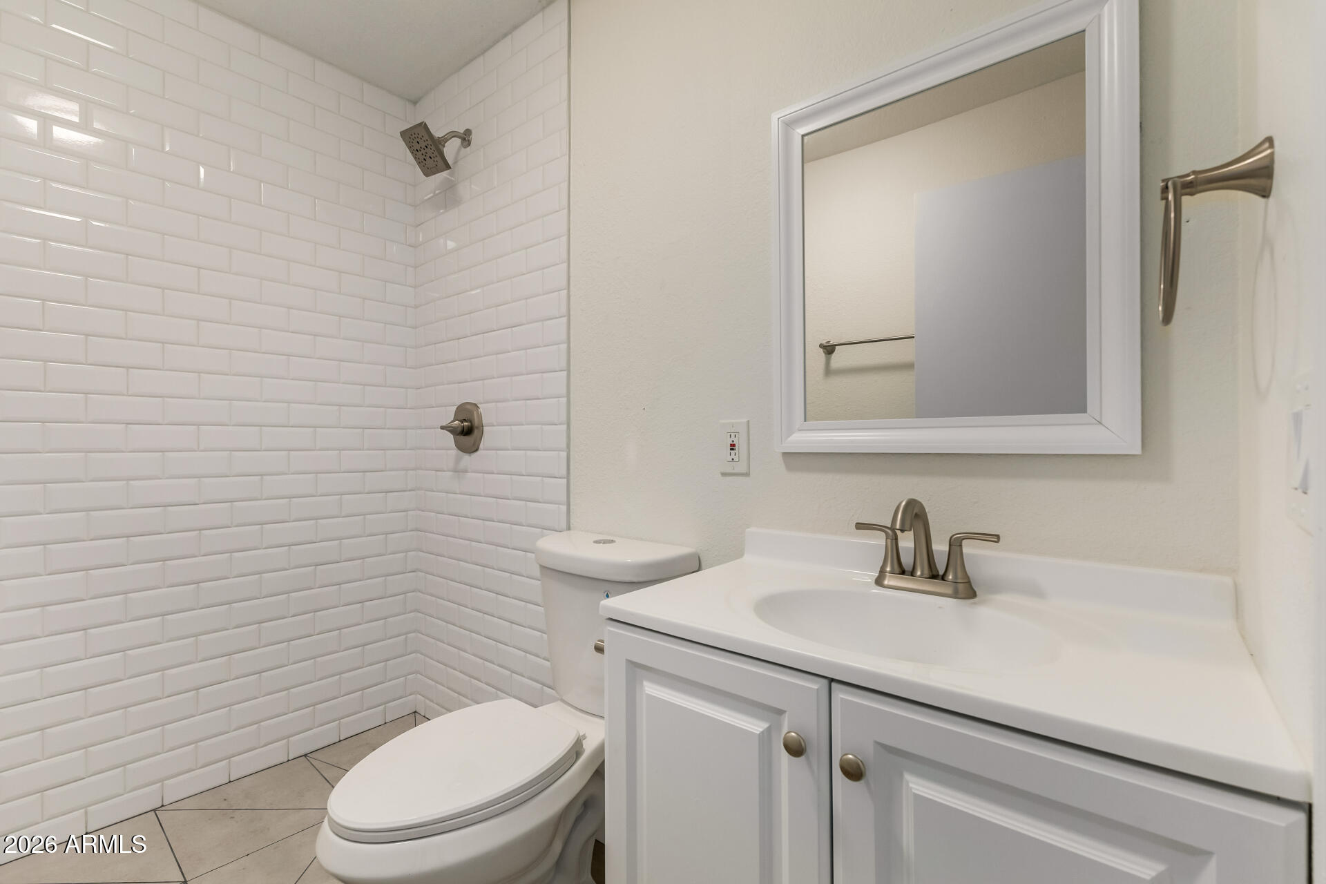 936 West Rio Salado Parkway, Unit 4 Mesa, AZ 85201 - Photo 14 of 20 a bathroom with a toilet sink vanity and mirror