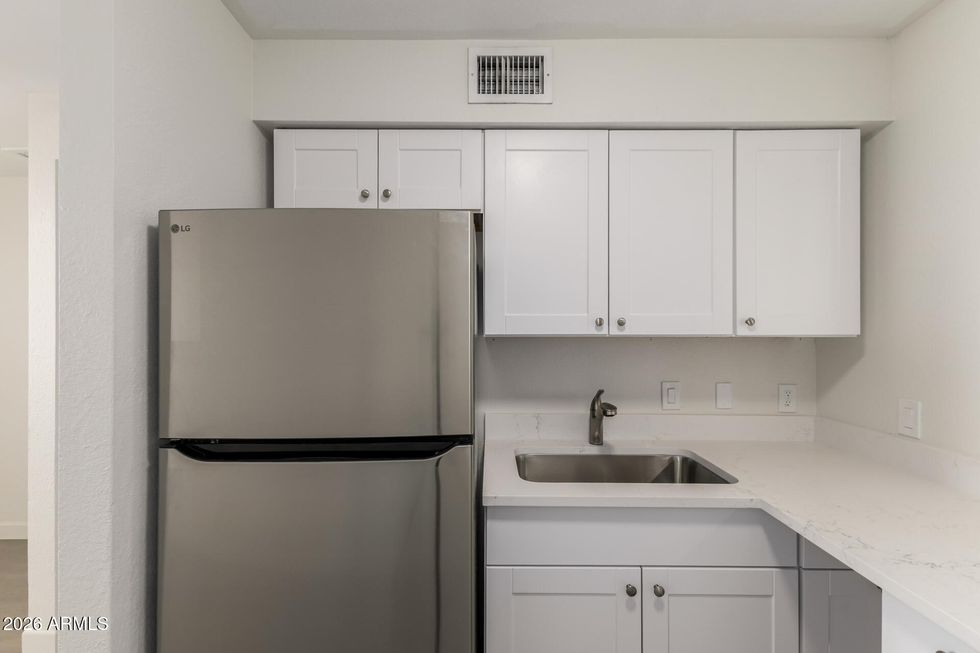 936 West Rio Salado Parkway, Unit 4 Mesa, AZ 85201 - Photo 7 of 20 a white refrigerator freezer sitting in a kitchen