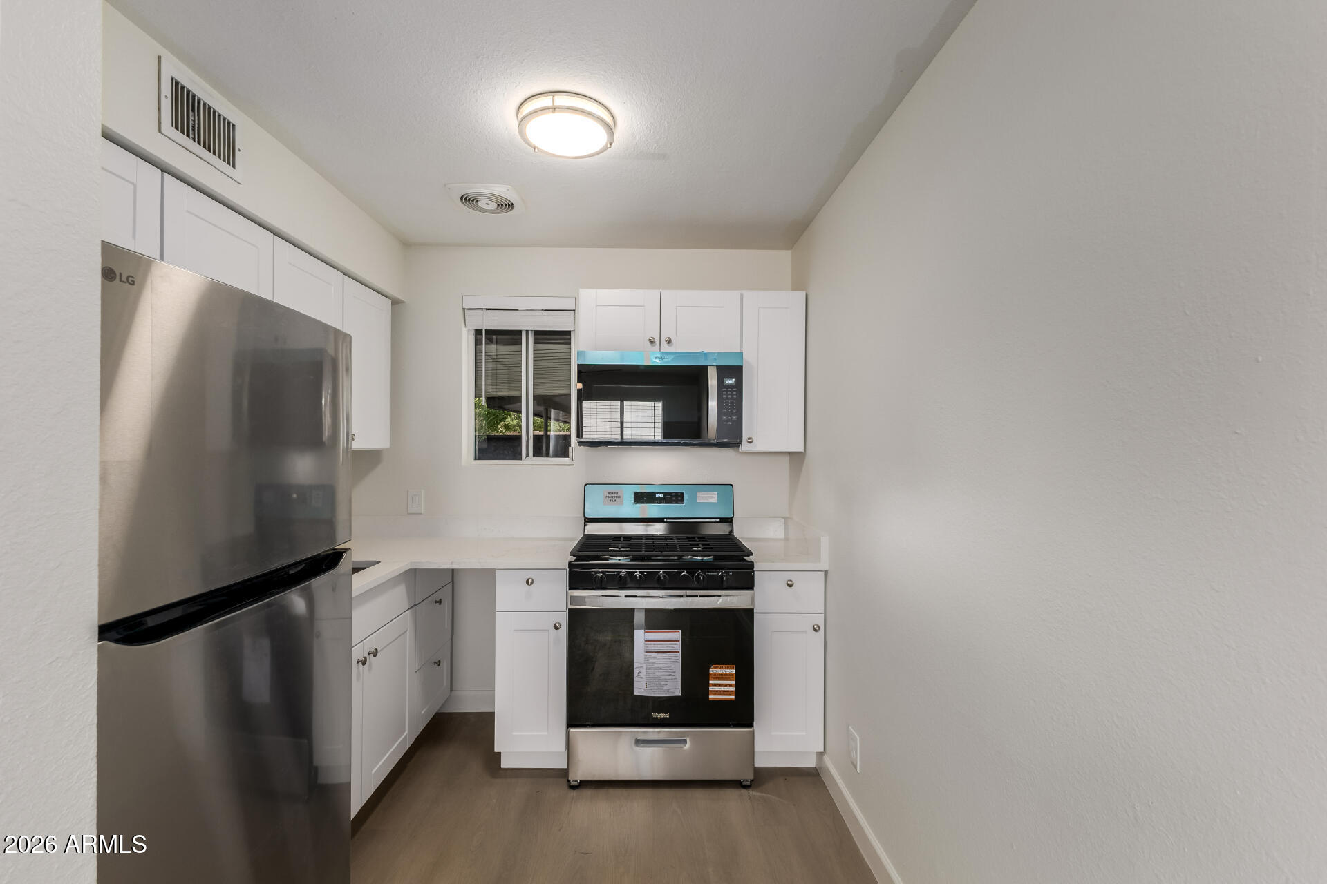 936 West Rio Salado Parkway, Unit 4 Mesa, AZ 85201 - Photo 8 of 20 a kitchen with a refrigerator and a stove top oven