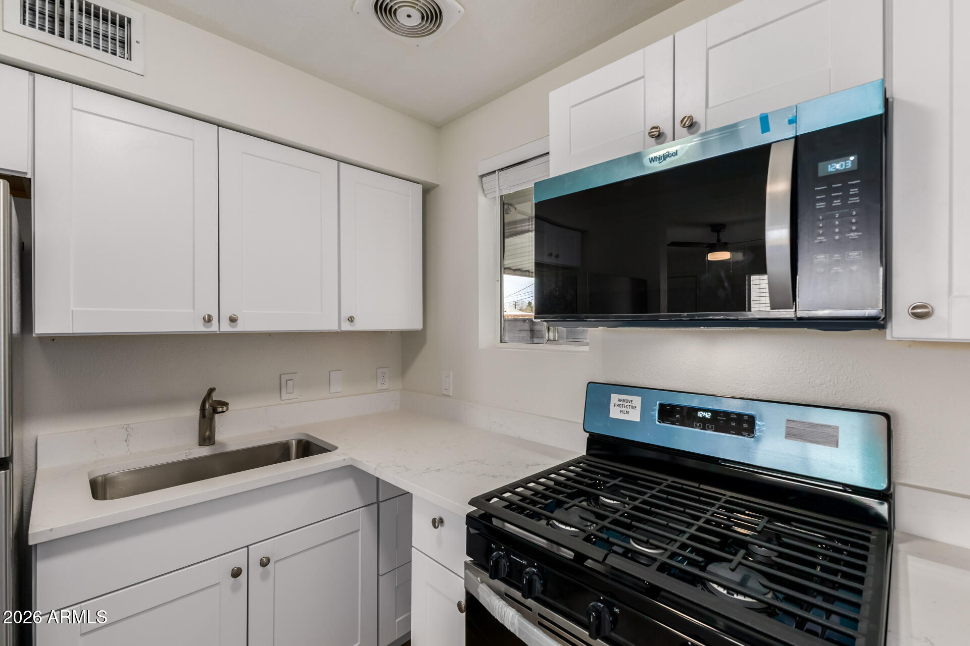 936 West Rio Salado Parkway, Unit 4 Mesa, AZ 85201 - Photo 9 of 20 a kitchen with a stove and a microwave