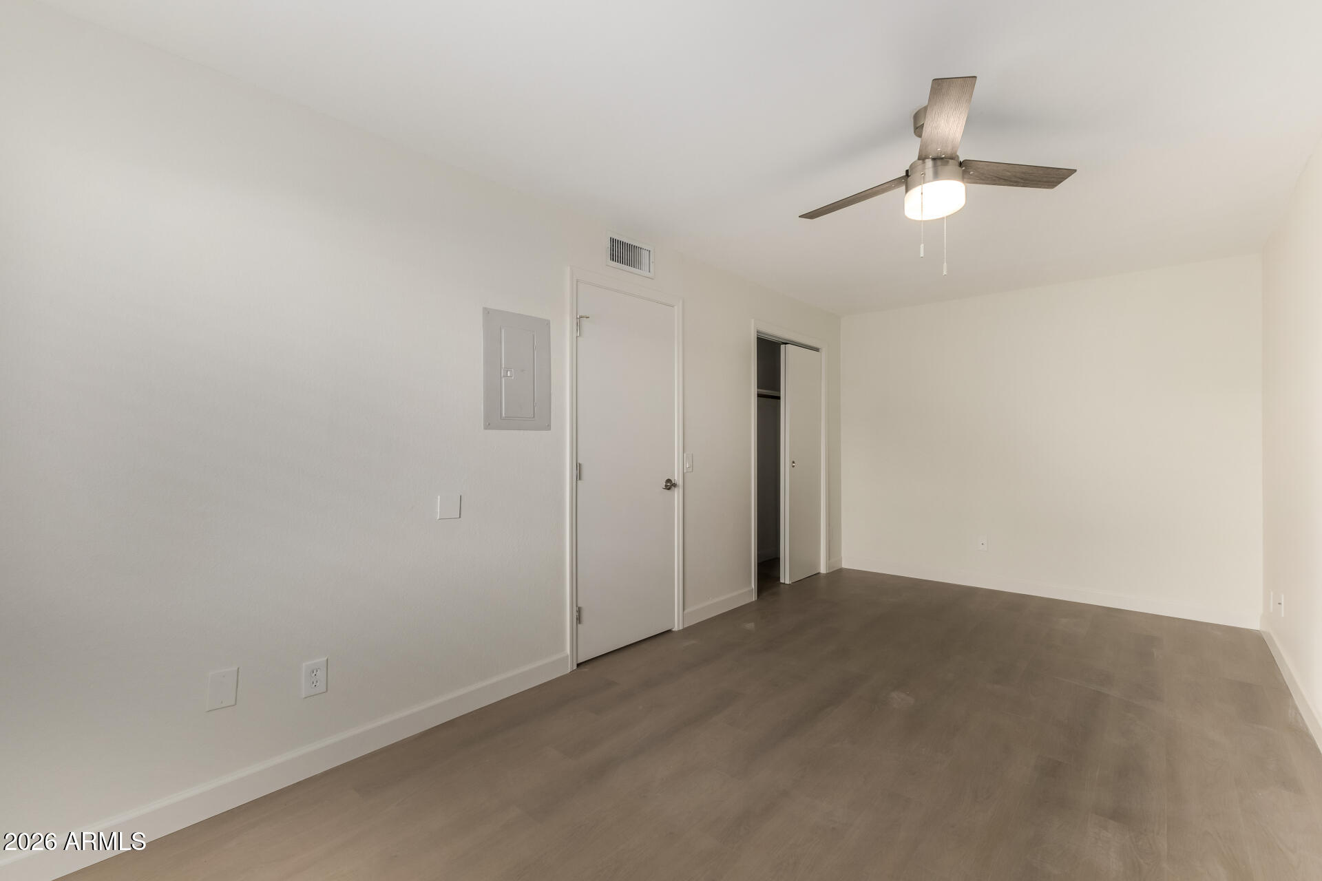 936 West Rio Salado Parkway, Unit 4 Mesa, AZ 85201 - Photo 10 of 20 an empty room with a empty space and a chandelier fan