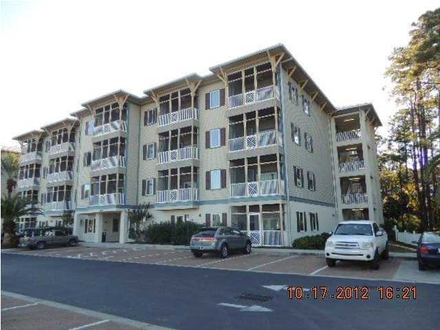 231 Somerset Bridge Road, Unit 2202 Santa Rosa Beach, FL 32459 - Photo 1 of 16 a front view of a building with lot of cars and trees