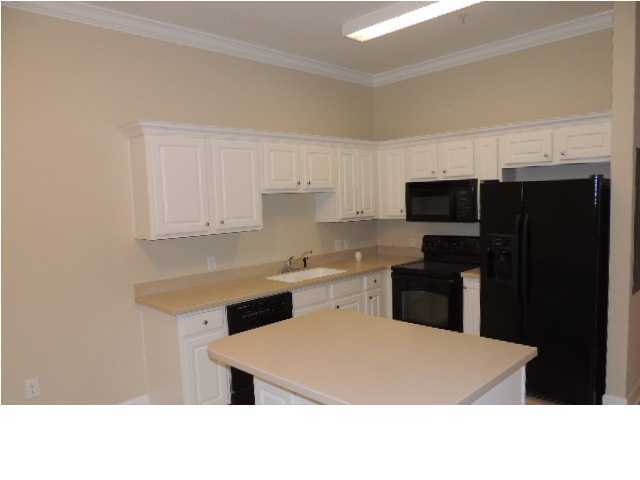 231 Somerset Bridge Road, Unit 2202 Santa Rosa Beach, FL 32459 - Photo 9 of 16 a kitchen with a refrigerator sink and cabinets