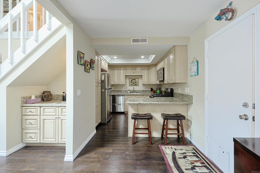 1415 1st Street Coronado, CA 92118 - Photo 11 of 36 a kitchen with stainless steel appliances granite countertop a refrigerator and a stove top oven