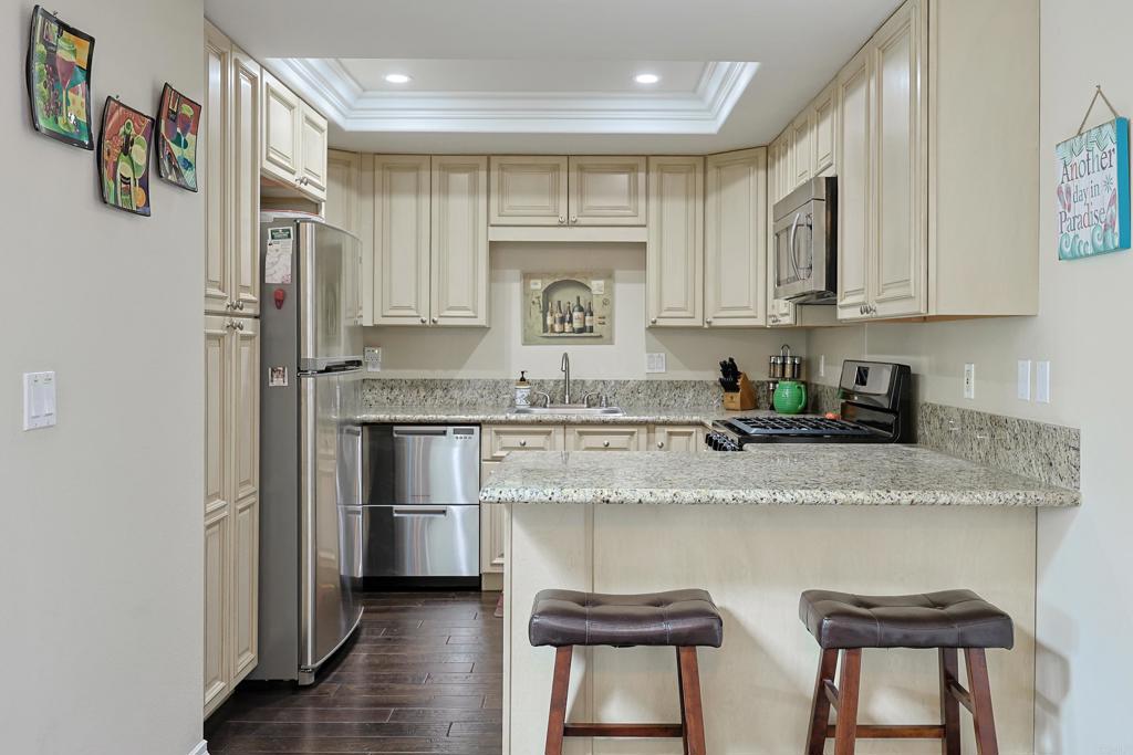 1415 1st Street Coronado, CA 92118 - Photo 12 of 36 a kitchen with stainless steel appliances granite countertop a stove a sink and a refrigerator
