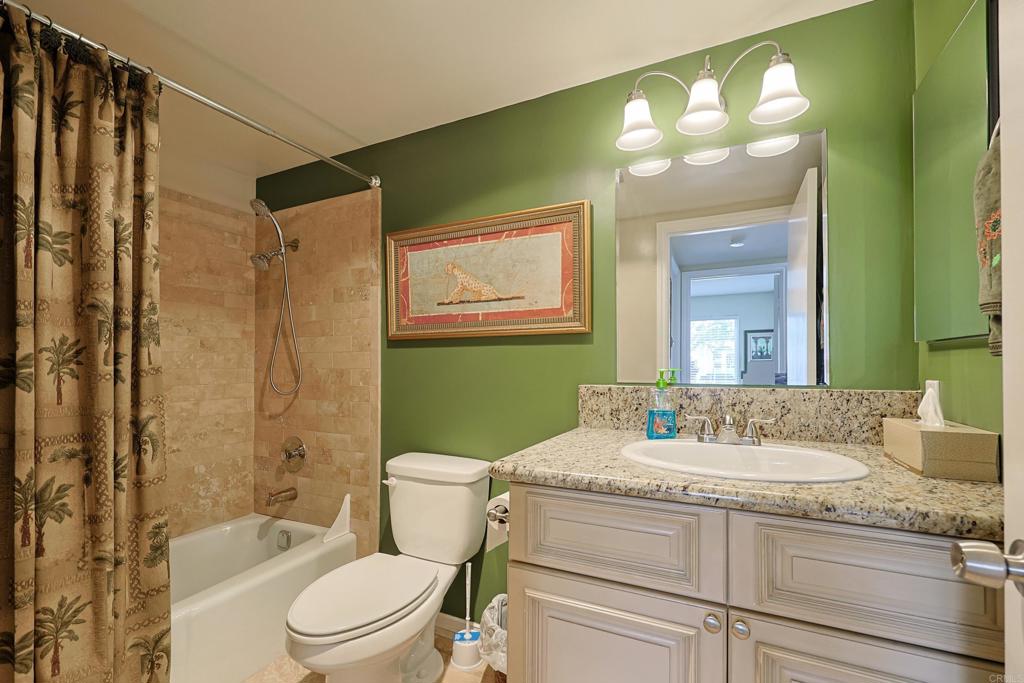 1415 1st Street Coronado, CA 92118 - Photo 18 of 36 a bathroom with a granite countertop sink toilet tub and shower