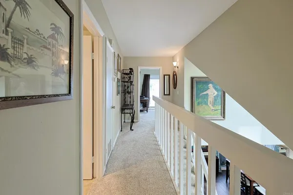 a view of a hallway with wooden floor and entryway