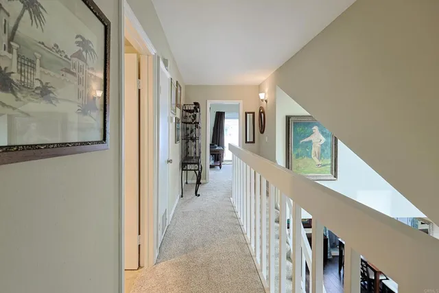 a view of a hallway with wooden floor and entryway