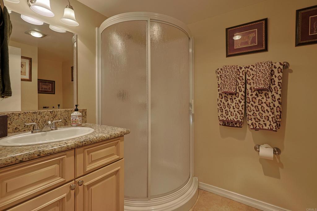 1415 1st Street Coronado, CA 92118 - Photo 29 of 36 a bathroom with a granite countertop sink and a mirror