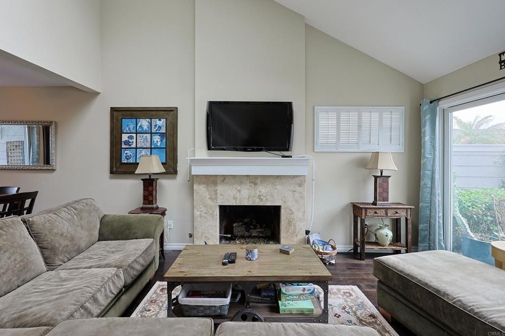 1415 1st Street Coronado, CA 92118 - Photo 5 of 36 a living room with furniture a flat screen tv and a fireplace