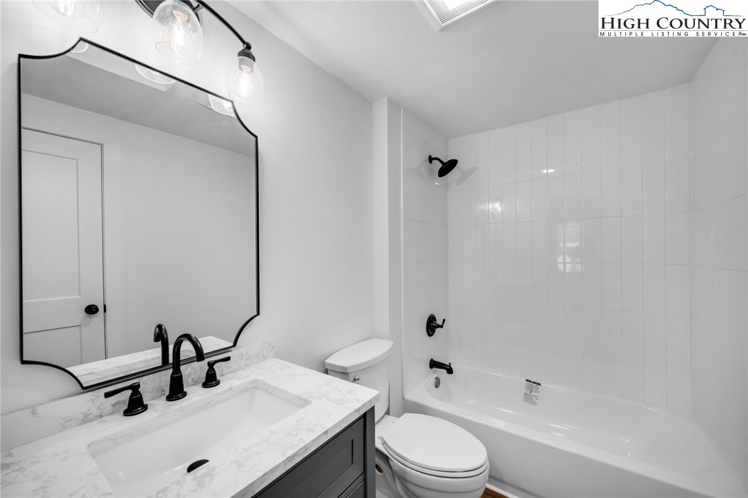 208 Meadow Loop Newland, NC 28657 - Photo 16 of 46 a bathroom with a sink and a mirror