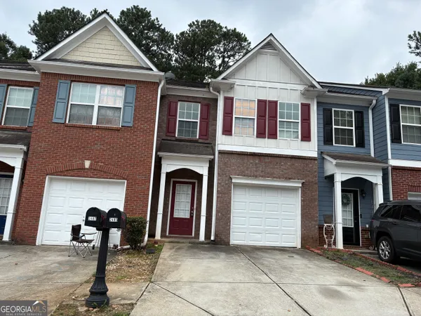 a front view of a house with parking space