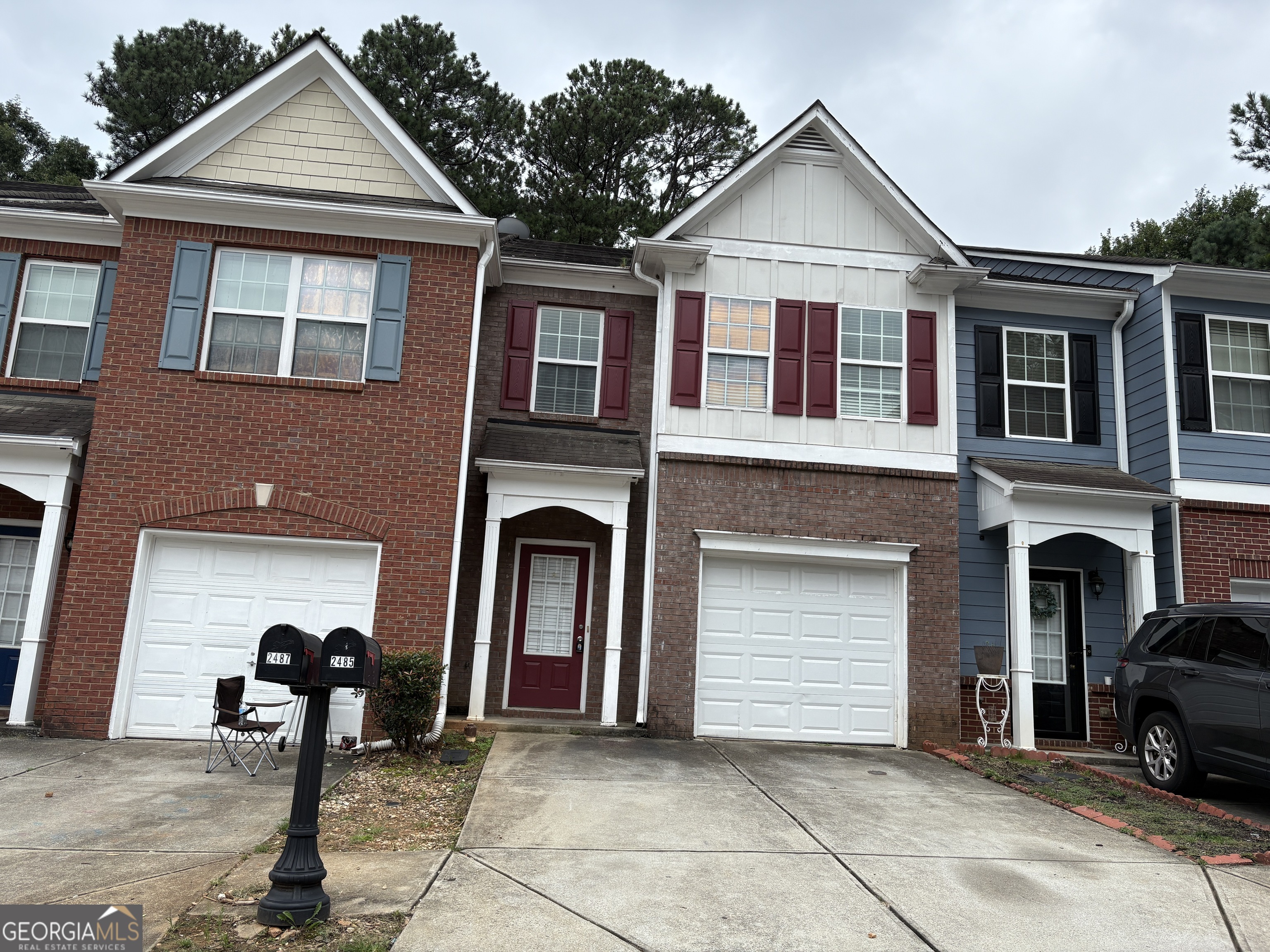a front view of a house with parking space