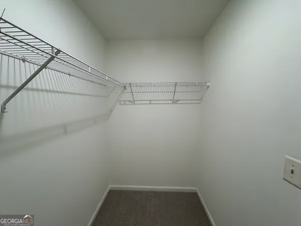 a view of storage and utility room with racks on the wall