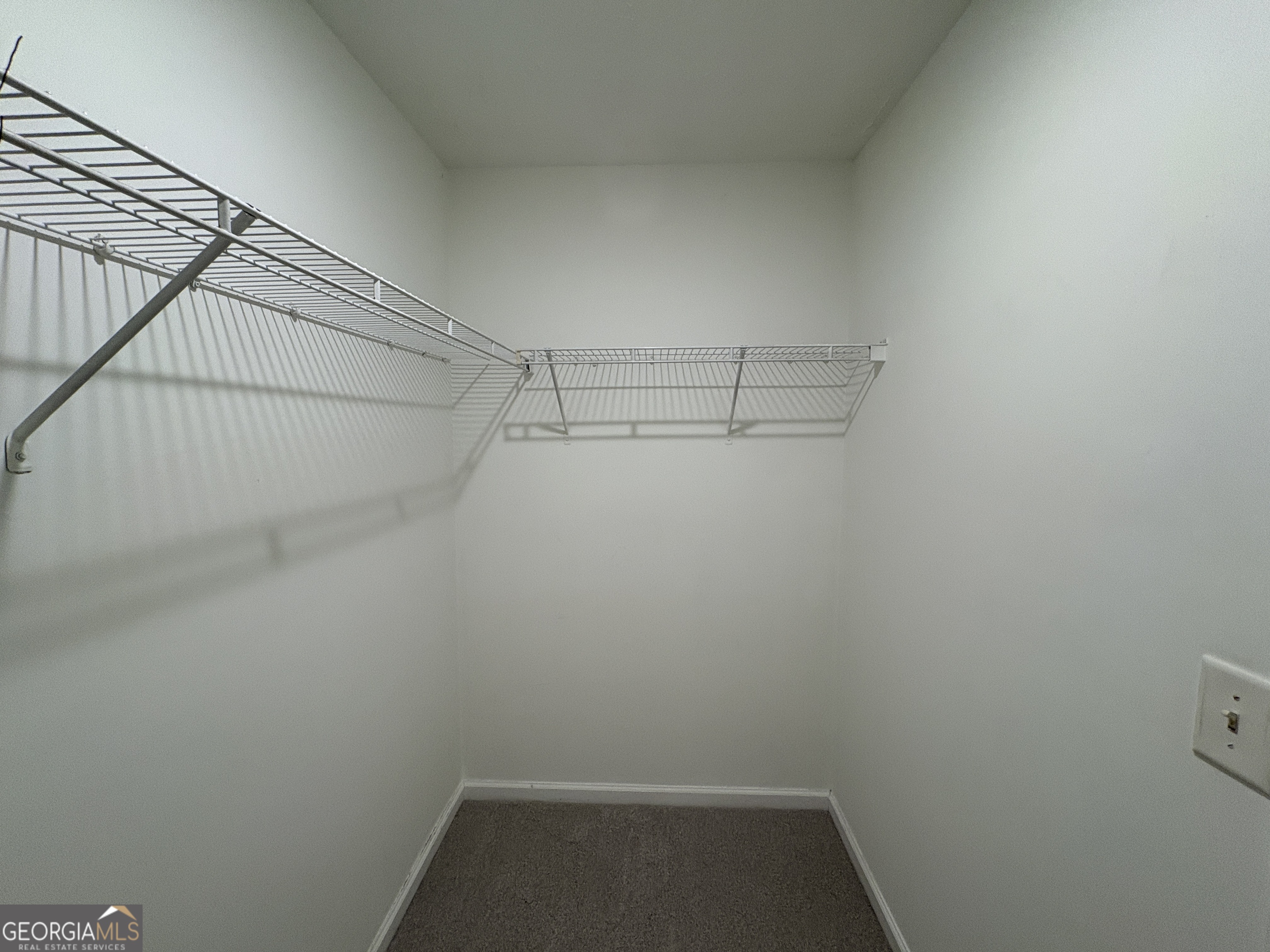 2485 Emma Way Northwest, Unit 2485 Lawrenceville, GA 30044 - Photo 13 of 20 a view of storage and utility room with racks on the wall