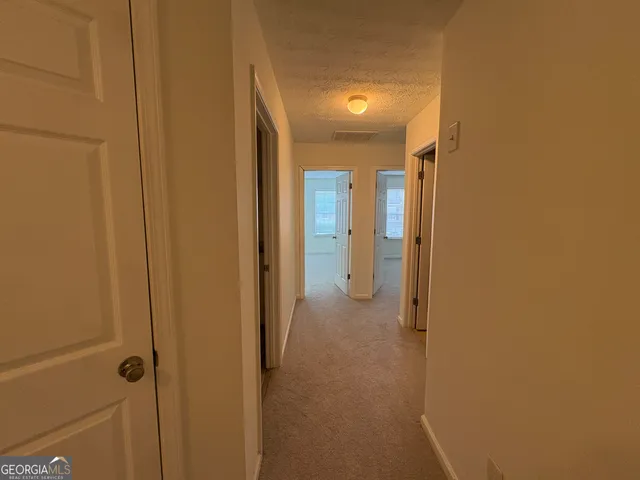 a view of a bathroom from a hallway