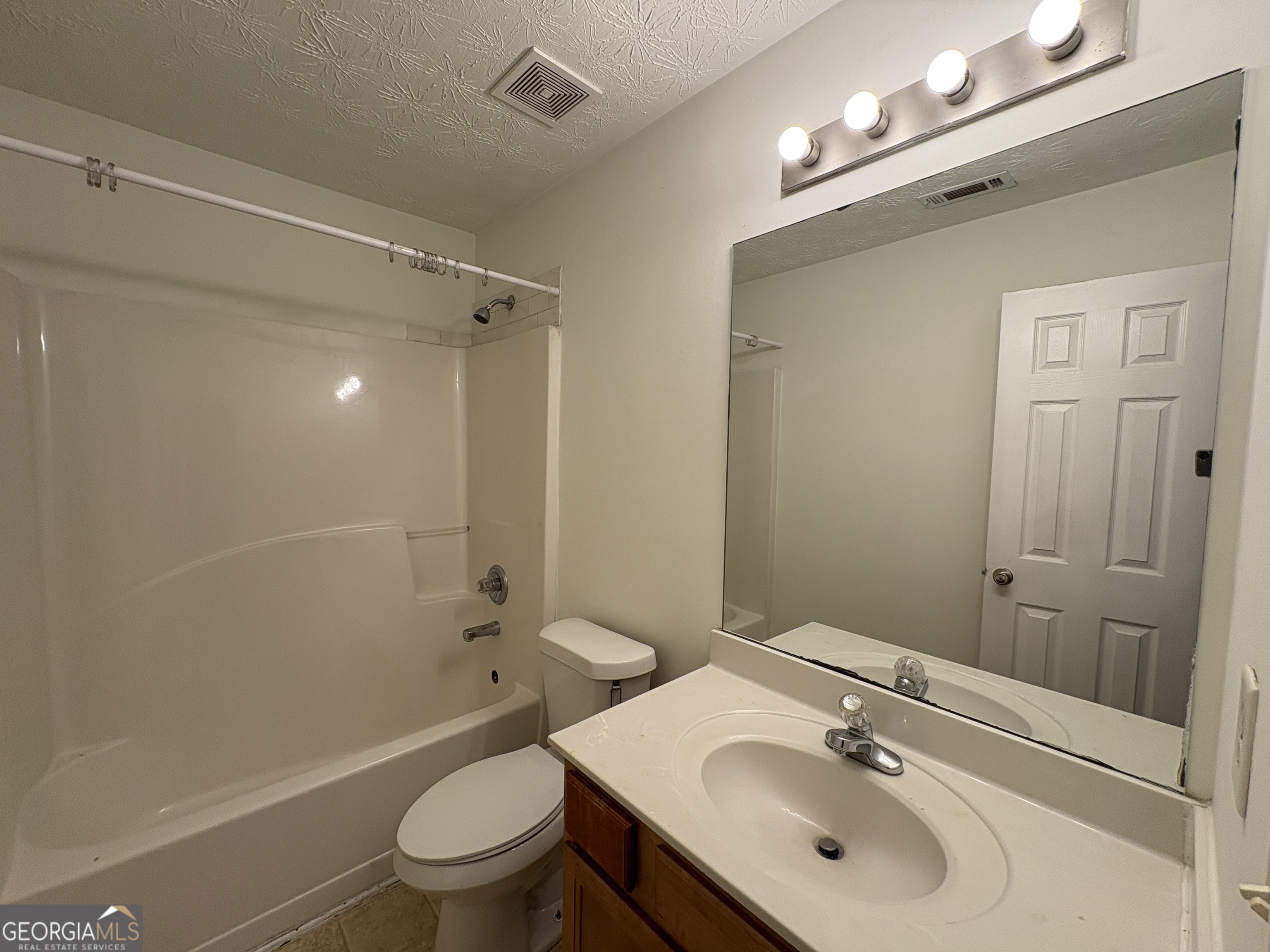 2485 Emma Way Northwest, Unit 2485 Lawrenceville, GA 30044 - Photo 16 of 20 a bathroom with a sink a toilet and shower