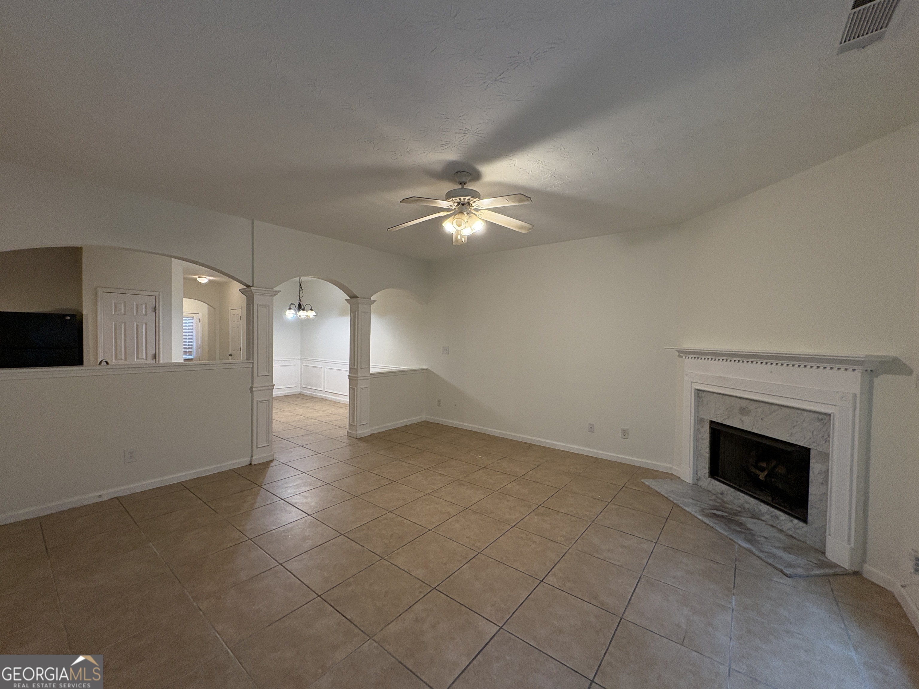2485 Emma Way Northwest, Unit 2485 Lawrenceville, GA 30044 - Photo 7 of 20 a view of an empty room with chandelier fan and fire place