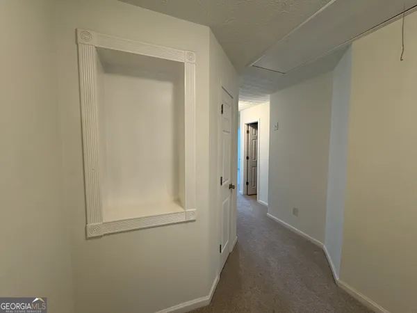 a view of a hallway with closet