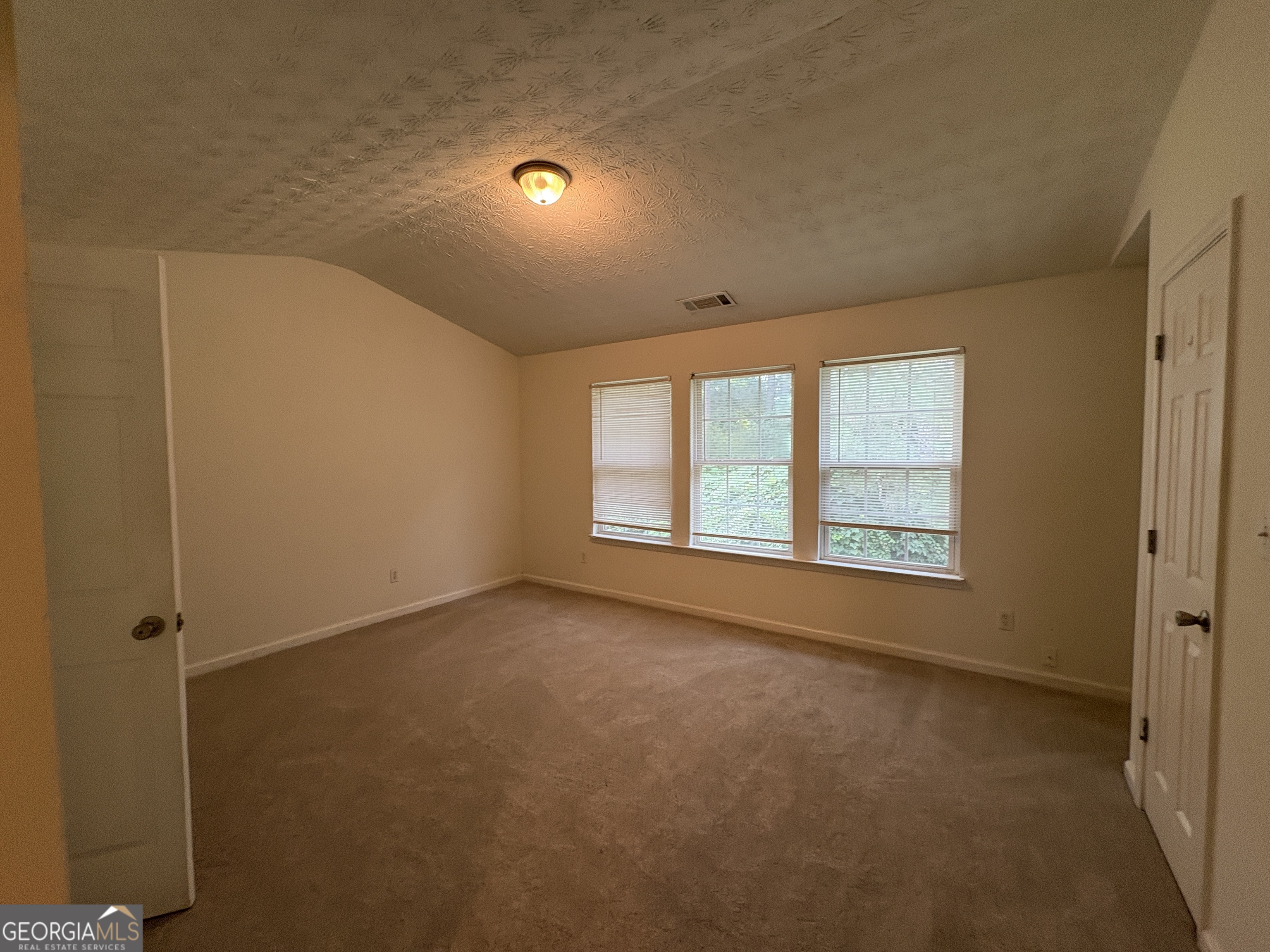 2485 Emma Way Northwest, Unit 2485 Lawrenceville, GA 30044 - Photo 9 of 20 an empty room with windows