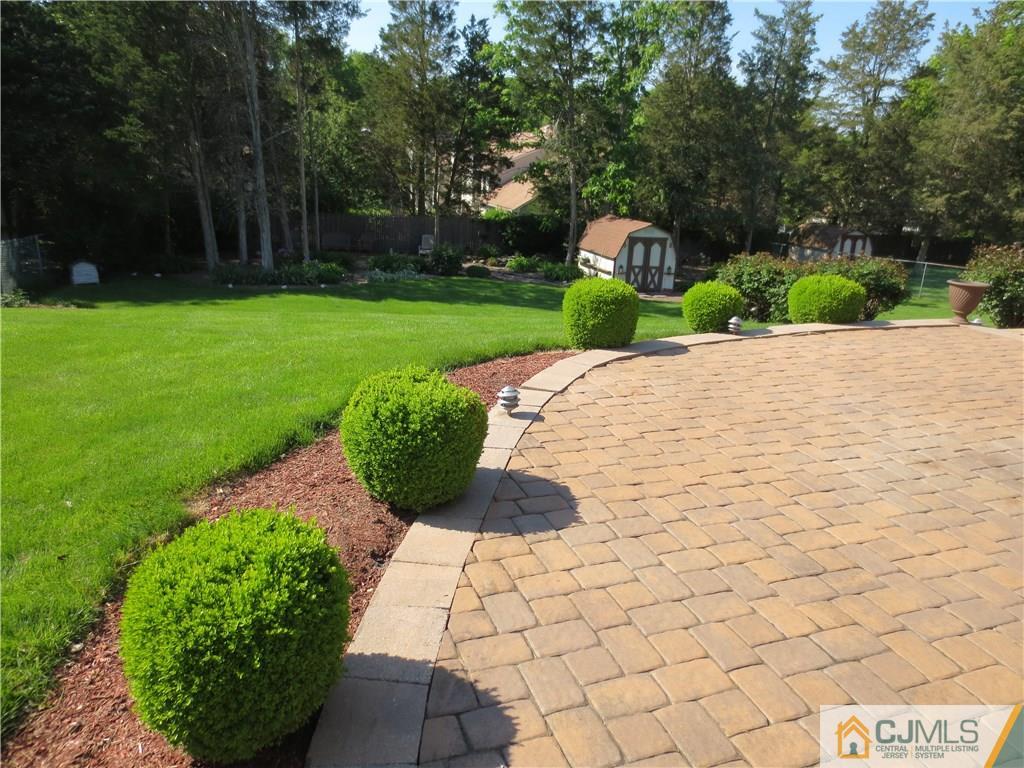 512 New Brunswick Road Somerset, NJ 08873 - Photo 22 of 24 a front view of a house with a yard and shrubs