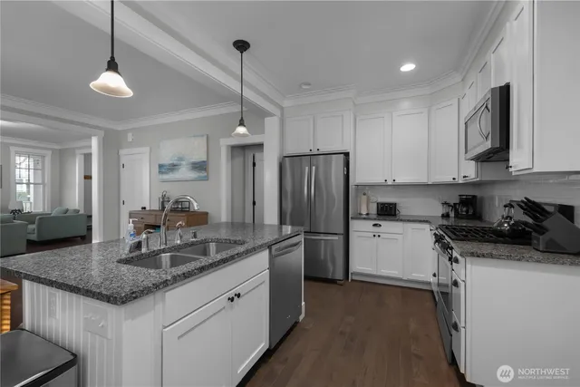 a kitchen with a refrigerator a sink and a stove