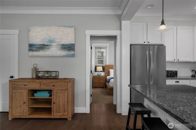 a kitchen with kitchen island a counter top space a sink stainless steel appliances and cabinets