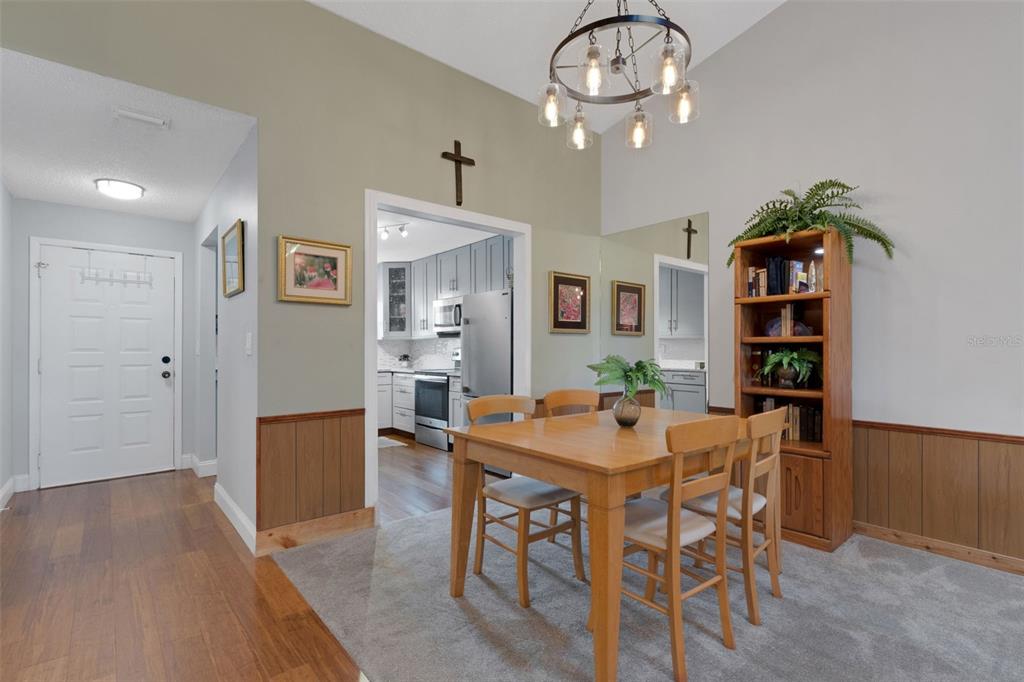 1065 Tartan Drive, Unit C Palm Harbor, FL 34684 - Photo 13 of 91 a view of a dining room with furniture and wooden floor