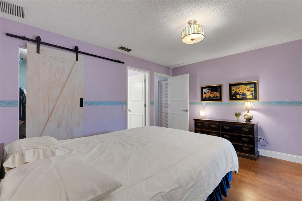 1065 Tartan Drive, Unit C Palm Harbor, FL 34684 - Photo 26 of 91 a bedroom with a bed and a desk